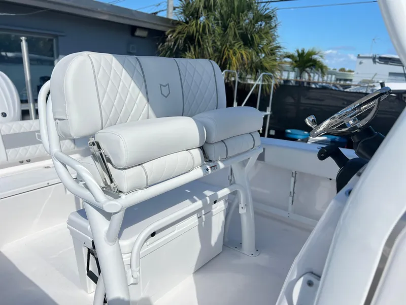 Slide: The Image of 2025 Sea Fox 248 Commander boat interior with white cushioned seating and steering wheel. - 31