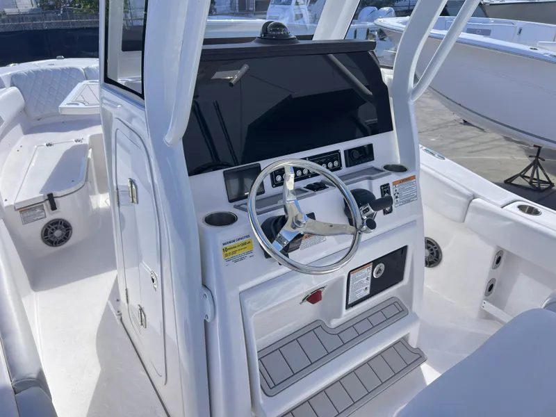 Slide: The Image of 2025 Sea Fox 248 Commander boat cockpit with steering wheel and control panel. - 33