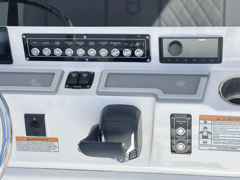 Slide: The Image of Control panel of 2025 Sea Fox 248 Commander boat with switches and warnings. - 36