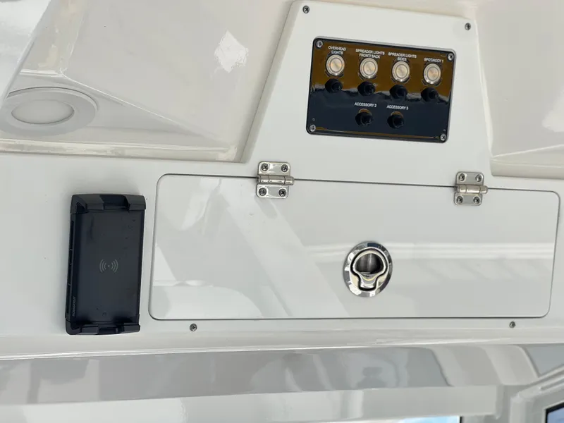 Slide: The Image of Control panel of 2025 Sea Fox 248 Commander boat with switches and storage compartment. - 38