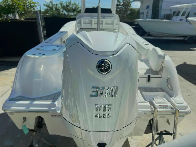 Slide: The Image of 2025 Sea Fox 248 Commander boat with powerful outboard motor in a sunny marina. - 4