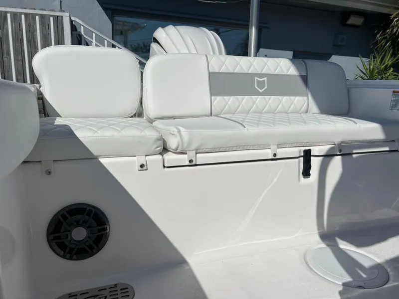 Slide: The Image of 2025 Sea Fox 248 Commander boat with white cushioned seating and speaker. - 46