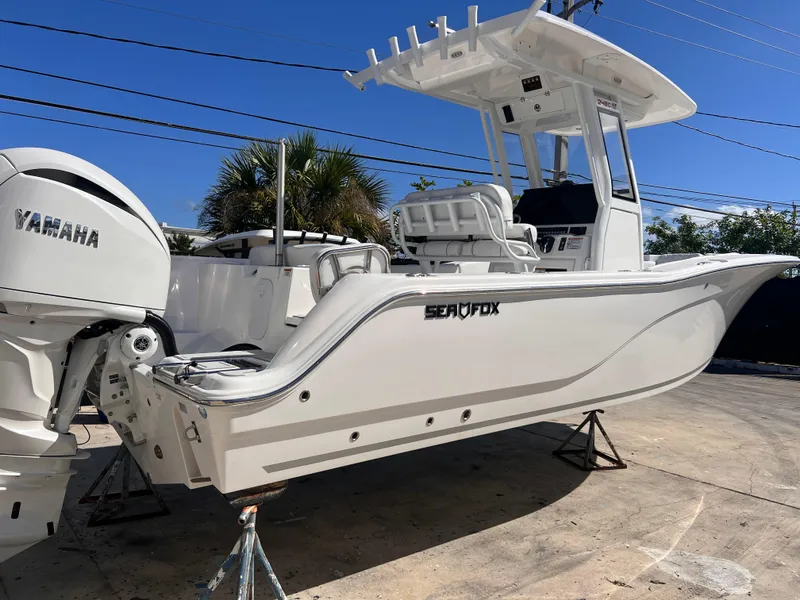 Slide: The Image of 2025 Sea Fox 248 Commander boat with Yamaha engine, displayed outdoors on a sunny day. - 5