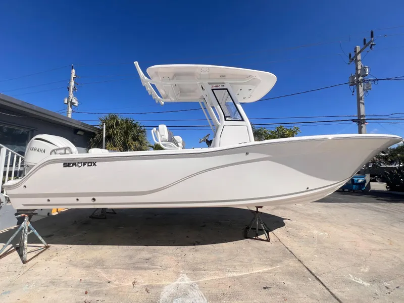 Slide: The Image of 2025 Sea Fox 248 Commander boat on display, side view, clear blue sky background. - 6