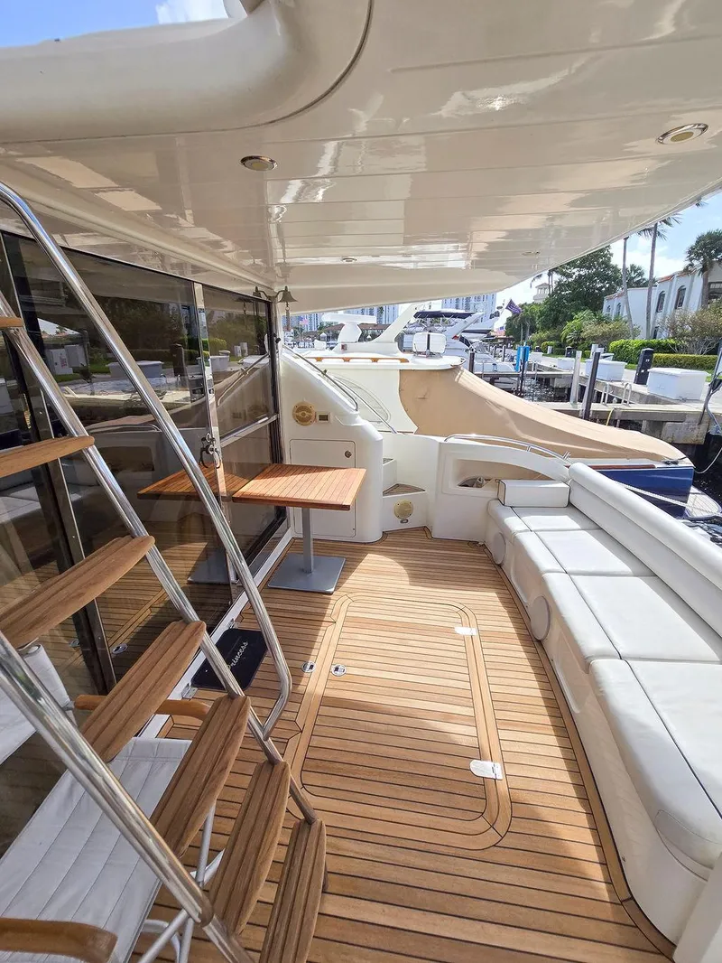Slide: The Image of 1998 Viking Princess 56 Sport Cruiser with teak deck and seating area. - 12