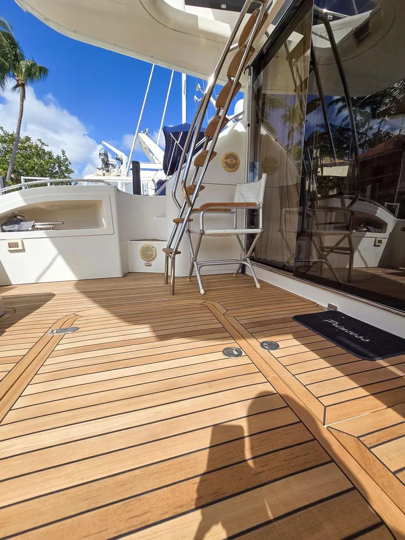 Slide: The Image of 1998 Viking Princess 56 Sport Cruiser, teak deck, outdoor seating, sunny day, luxury yacht. - 16