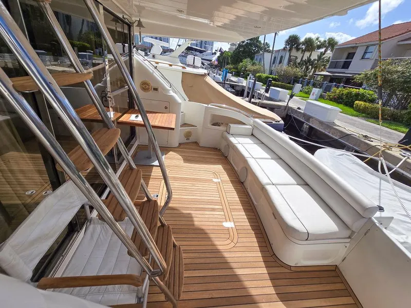 Slide: The Image of 1998 Viking Princess 56 Sport Cruiser yacht with spacious deck and seating area. - 18