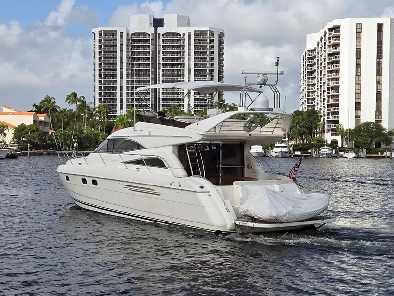 Slide: The Image of 1998 Viking Princess 56 Sport Cruiser yacht on water, city skyline background. - 2