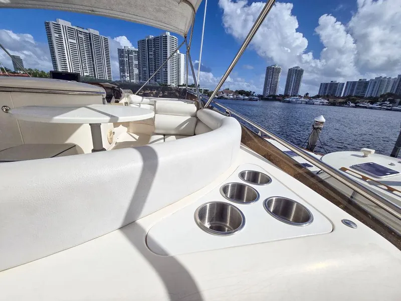 Slide: The Image of 1998 Viking Princess 56 Sport Cruiser, luxury yacht interior with cup holders, city skyline view. - 21