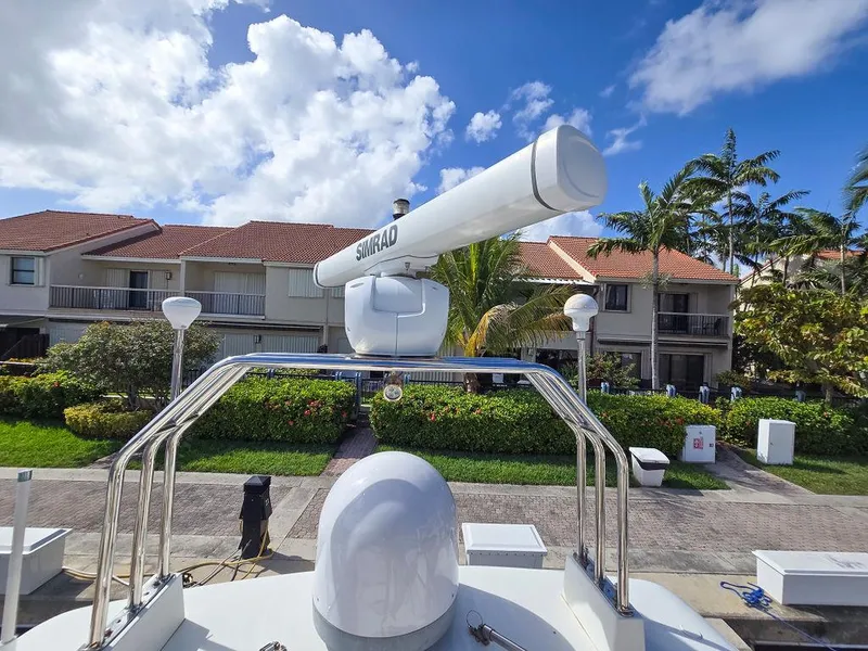 Slide: The Image of Viking Princess 56 Sport Cruiser 1998 with radar, docked near residential area under blue sky. - 22