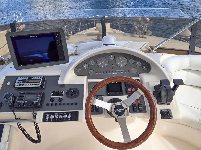 Slide: The Image of 1998 Viking Princess 56 Sport Cruiser helm with navigation equipment and wooden steering wheel. - 25
