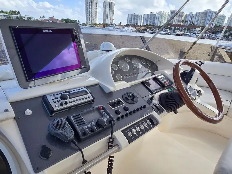 Slide: The Image of 1998 Viking Princess 56 Sport Cruiser helm with navigation equipment and city skyline view. - 27