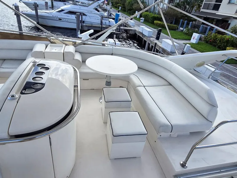 Slide: The Image of 1998 Viking Princess 56 Sport Cruiser with elegant white seating and outdoor dining area. - 29