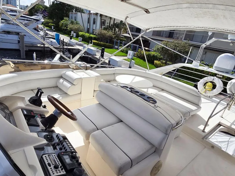 Slide: The Image of 1998 Viking Princess 56 Sport Cruiser yacht interior with luxurious seating and control panel. - 30