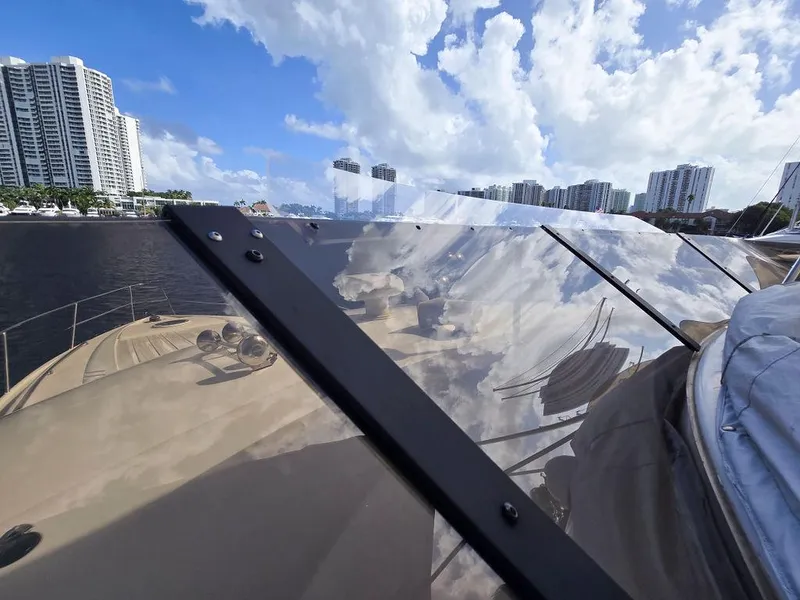 Slide: The Image of 1998 Viking Princess 56 Sport Cruiser with city skyline and blue sky reflection. - 31