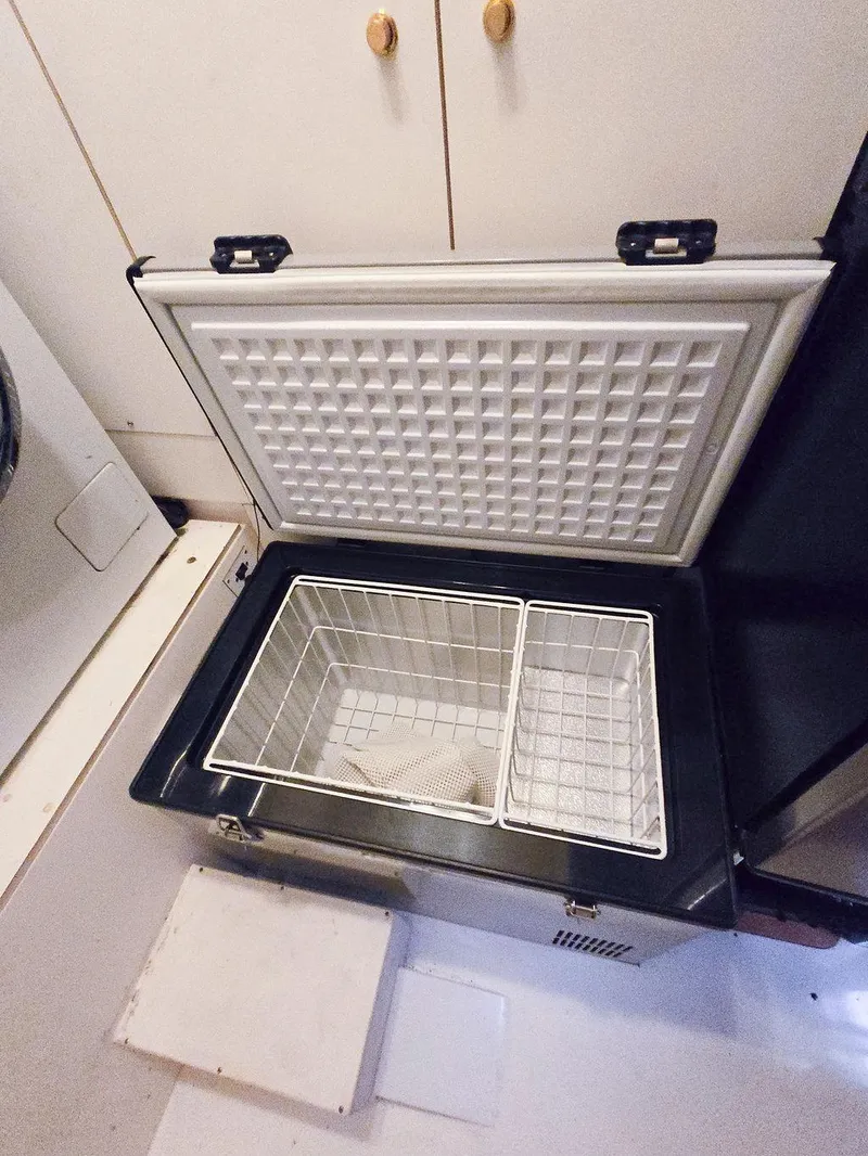 Slide: The Image of Open freezer with wire baskets inside a 1998 Viking Princess 56 Sport Cruiser. - 32