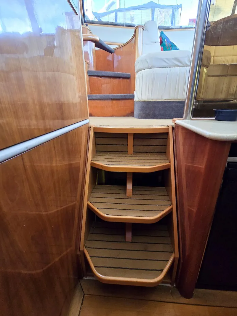 Slide: The Image of Wooden interior stairs on a 1998 Viking Princess 56 Sport Cruiser yacht. - 34