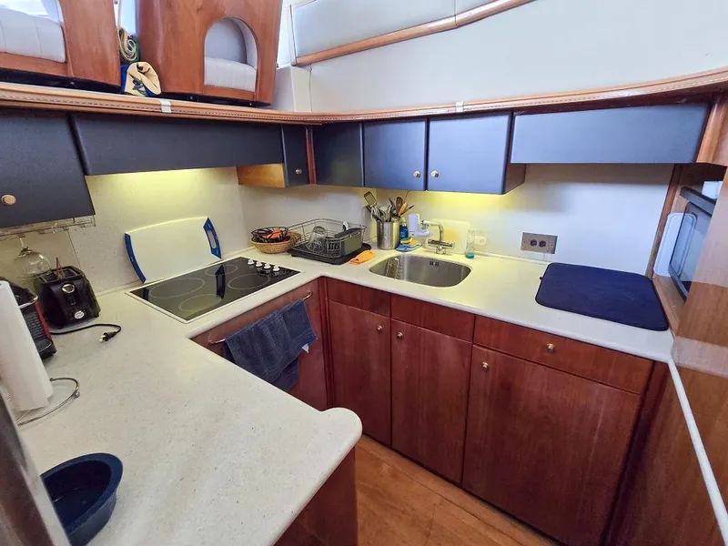 Slide: The Image of 1998 Viking Princess 56 Sport Cruiser kitchen with modern appliances and wooden cabinetry. - 35