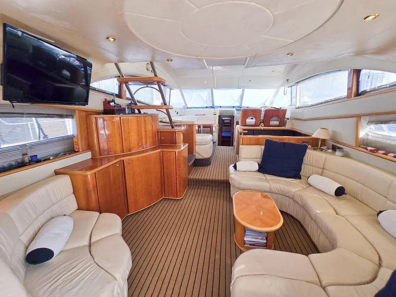 Slide: The Image of Luxurious interior of 1998 Viking Princess 56 Sport Cruiser with elegant seating and wood finishes. - 38