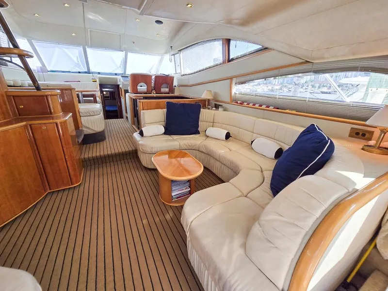 Slide: The Image of Luxurious interior of 1998 Viking Princess 56 Sport Cruiser with elegant seating and wooden accents. - 39