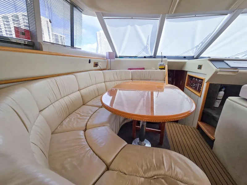 Slide: The Image of Luxurious interior of 1998 Viking Princess 56 Sport Cruiser with leather seating and wooden table. - 42