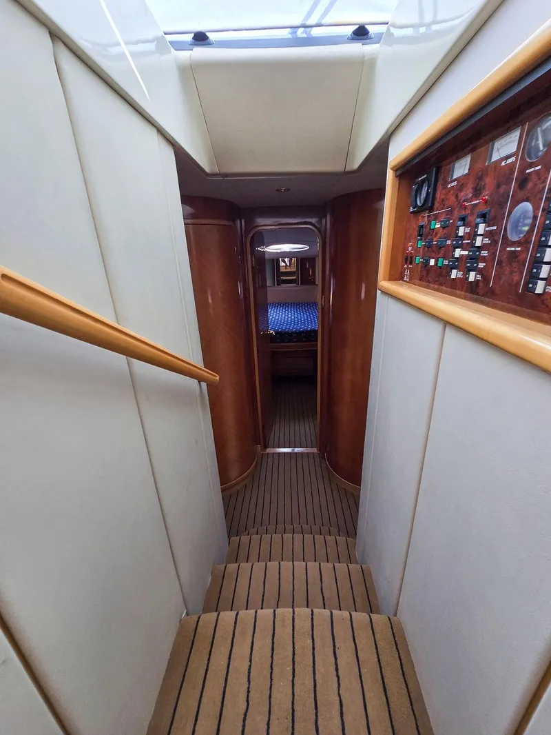 Slide: The Image of Interior hallway of 1998 Viking Princess 56 Sport Cruiser with wood paneling and control panel. - 43