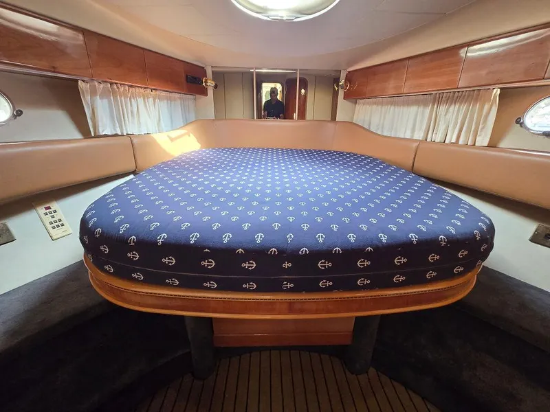 Slide: The Image of 1998 Viking Princess 56 Sport Cruiser cabin with anchor-patterned bedspread. - 45