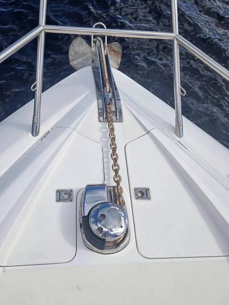 Slide: The Image of Bow of 1998 Viking Princess 56 Sport Cruiser with anchor chain and railing. - 5