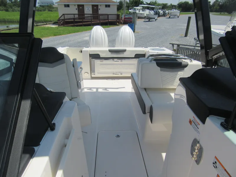 Slide: The Image of 2025 Robalo R257 Dual Console boat interior with seating and storage compartments. - 14
