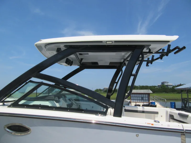 Slide: The Image of 2025 Robalo R257 Dual Console boat with sleek design and sturdy T-top. - 19