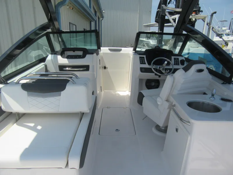 Slide: The Image of 2025 Robalo R257 Dual Console boat interior with white seating and modern dashboard. - 4