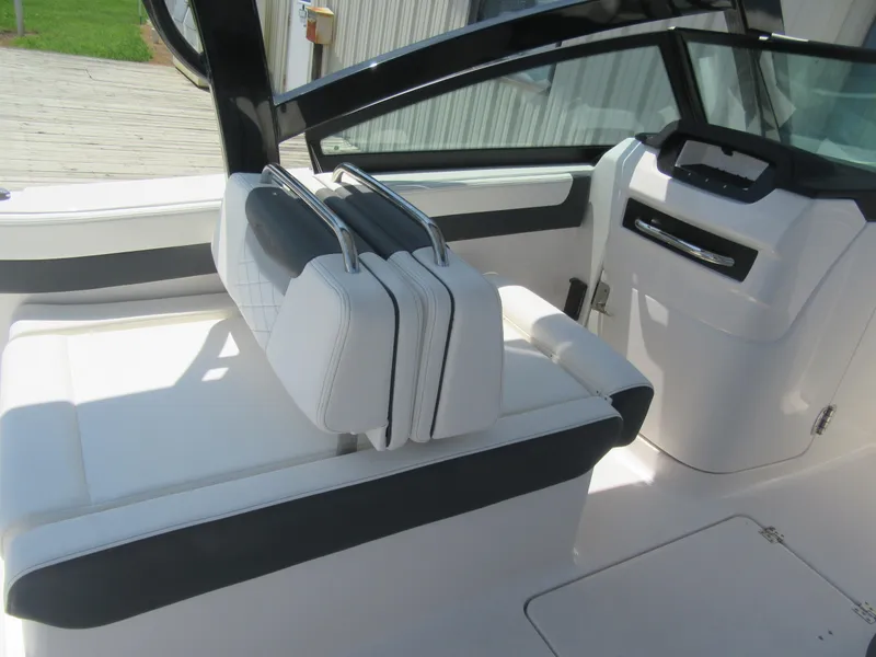 Slide: The Image of 2025 Robalo R257 Dual Console interior with white seating and sleek design. - 5