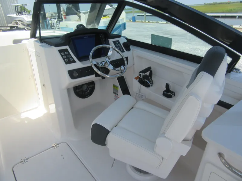 Slide: The Image of 2025 Robalo R257 Dual Console boat cockpit with modern steering and controls. - 6