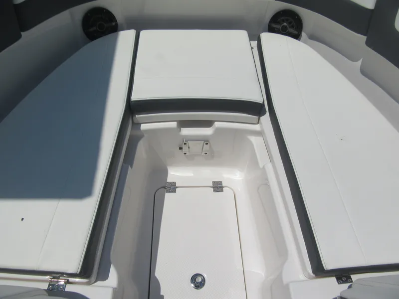 Slide: The Image of 2025 Robalo R257 Dual Console boat interior with cushioned seating and storage compartment. - 9