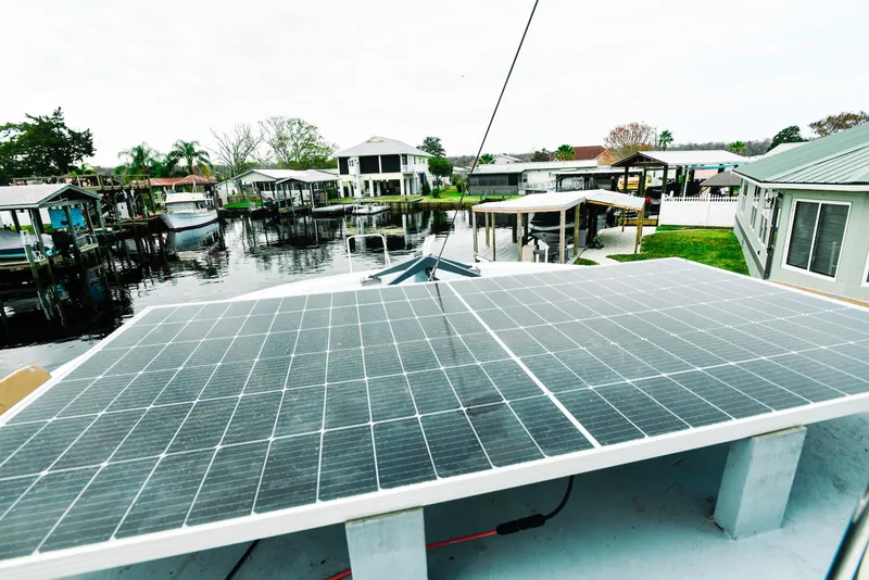 Slide: The Image of Solar panels on 1984 Kadey-Krogen Krogen 42 Trawler, docked near waterfront homes. - 11