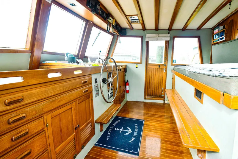 Slide: The Image of 1984 Kadey-Krogen Krogen 42 Trawler interior with wooden helm and nautical decor. - 15