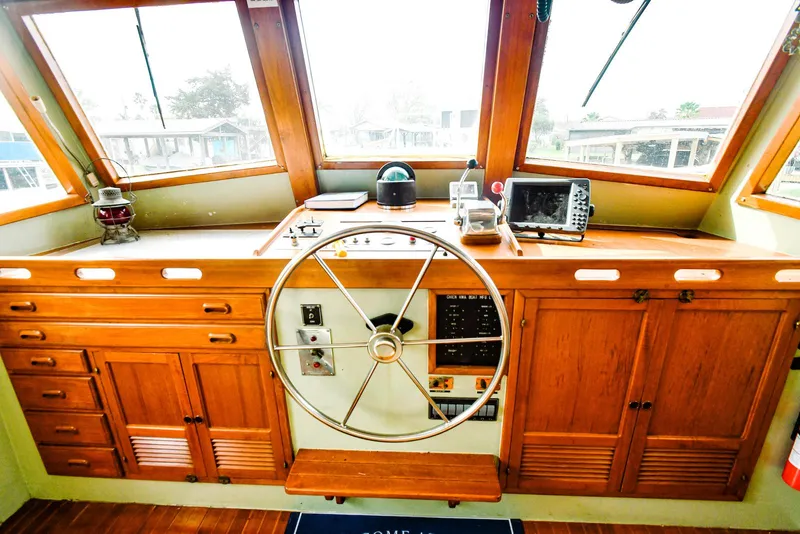 Slide: The Image of 1984 Kadey-Krogen Krogen 42 Trawler helm with wooden cabinetry and navigation equipment. - 16