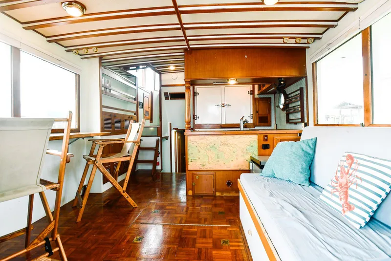 Slide: The Image of Interior of 1984 Kadey-Krogen Krogen 42 Trawler with wooden flooring and cozy seating. - 17