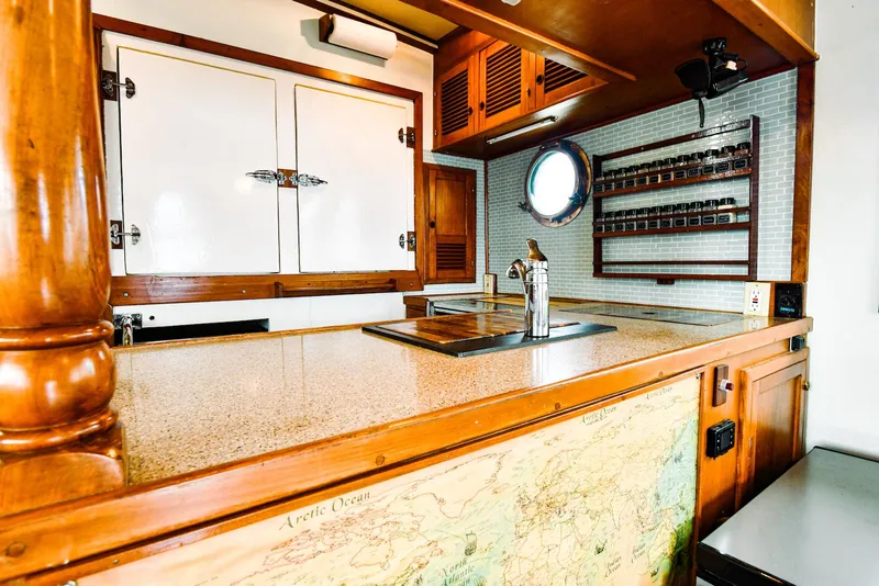 Slide: The Image of 1984 Kadey-Krogen Krogen 42 Trawler kitchen with wooden cabinetry and nautical decor. - 20