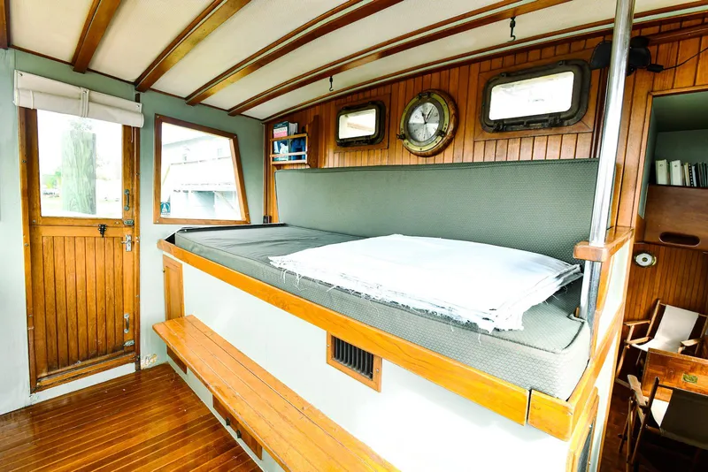 Slide: The Image of 1984 Kadey-Krogen Krogen 42 Trawler interior with wooden paneling and cozy seating area. - 21
