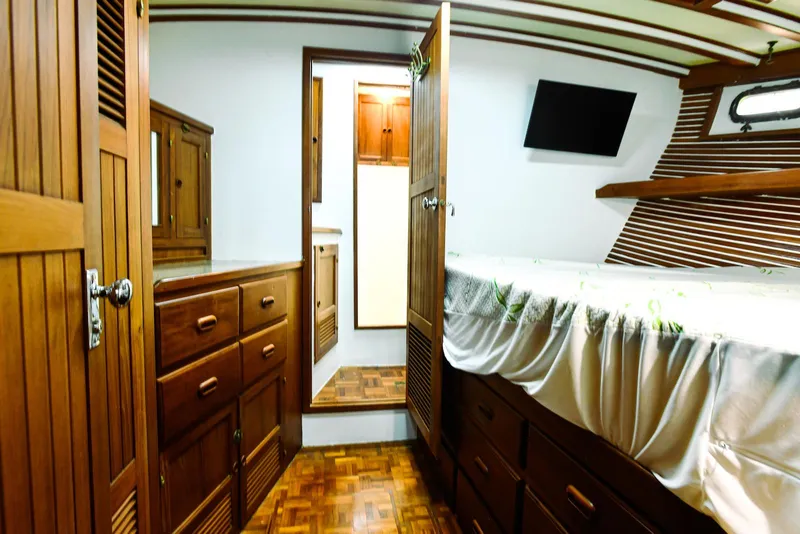 Slide: The Image of 1984 Kadey-Krogen Krogen 42 Trawler interior with wooden cabinetry and bed. - 24
