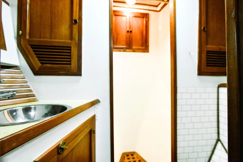 Slide: The Image of 1984 Kadey-Krogen Krogen 42 Trawler bathroom with wooden cabinets and sink. - 25
