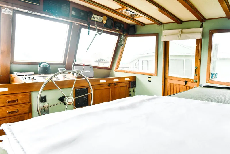 Slide: The Image of 1984 Kadey-Krogen Krogen 42 Trawler interior with wooden helm and large windows. - 28