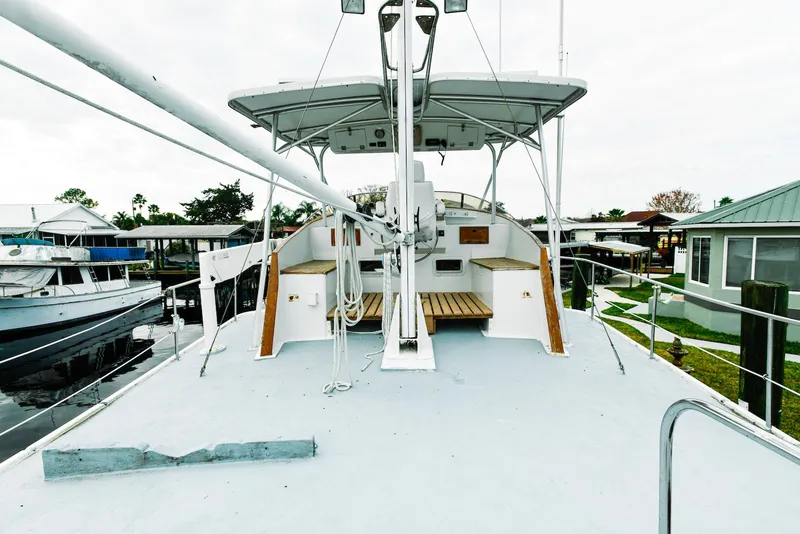 Slide: The Image of 1984 Kadey-Krogen Krogen 42 Trawler docked, showcasing spacious deck and helm area. - 3