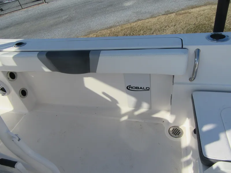 Slide: The Image of 2020 Robalo R230 Center Console boat interior with seating and storage. - 12