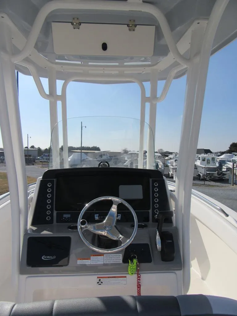 Slide: The Image of 2020 Robalo R230 Center Console boat dashboard with steering wheel and controls. - 17