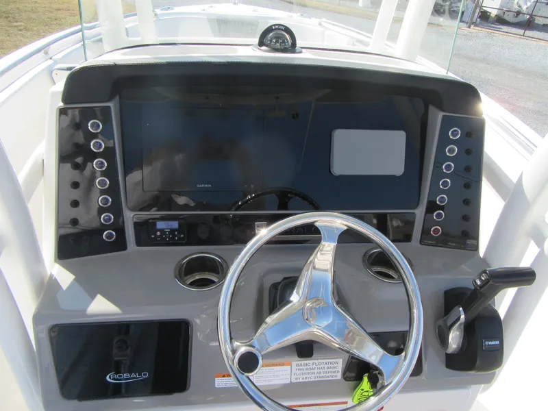 Slide: The Image of 2020 Robalo R230 Center Console boat dashboard with steering wheel and controls. - 20
