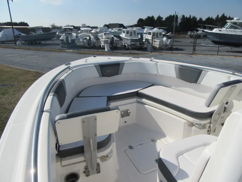 Slide: The Image of 2020 Robalo R230 Center Console boat interior with seating, docked among other boats. - 21