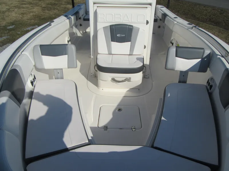 Slide: The Image of 2020 Robalo R230 Center Console boat interior with cushioned seating and storage. - 23