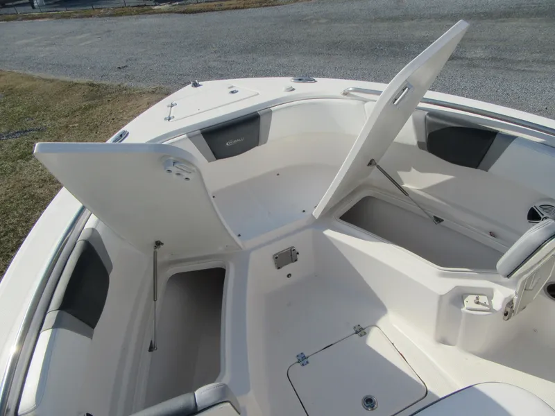 Slide: The Image of 2020 Robalo R230 Center Console boat with open storage compartments. - 27